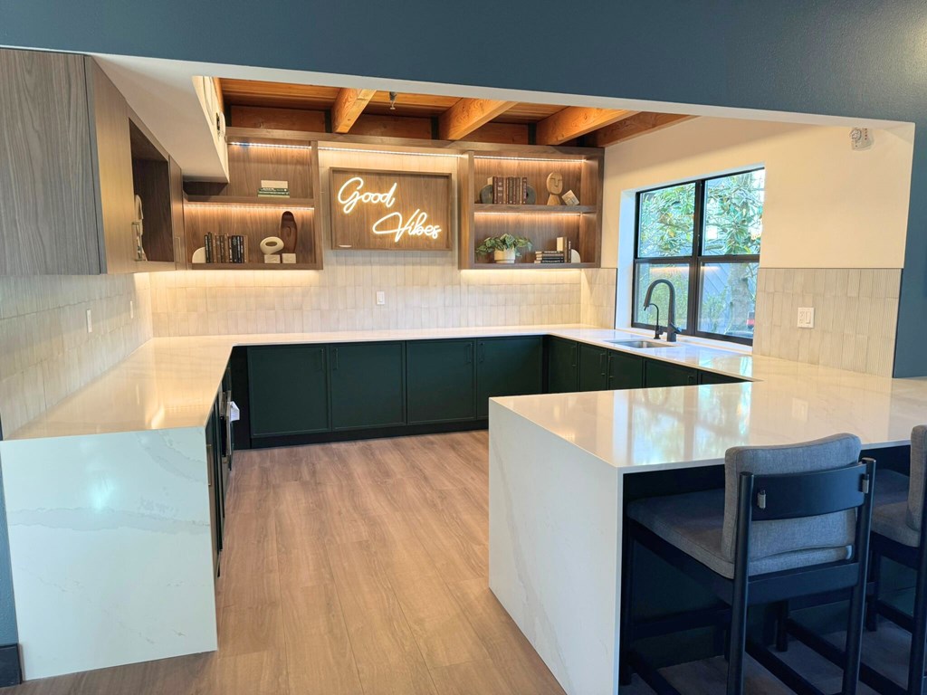 A kitchen with a white countertop and a neon sign that says Good Vibes A kitchen with a white countertop and a neon sign that says Good Vibes at The Lakes in Bellevue, 98007